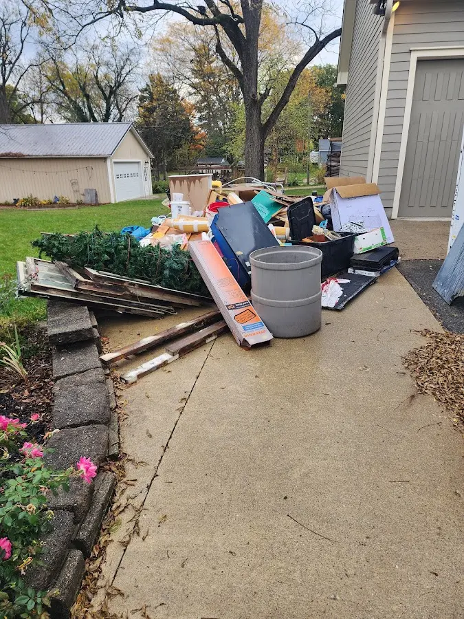 Dumpster being loaded with debris for Roofing Dumpster Rental in Erie